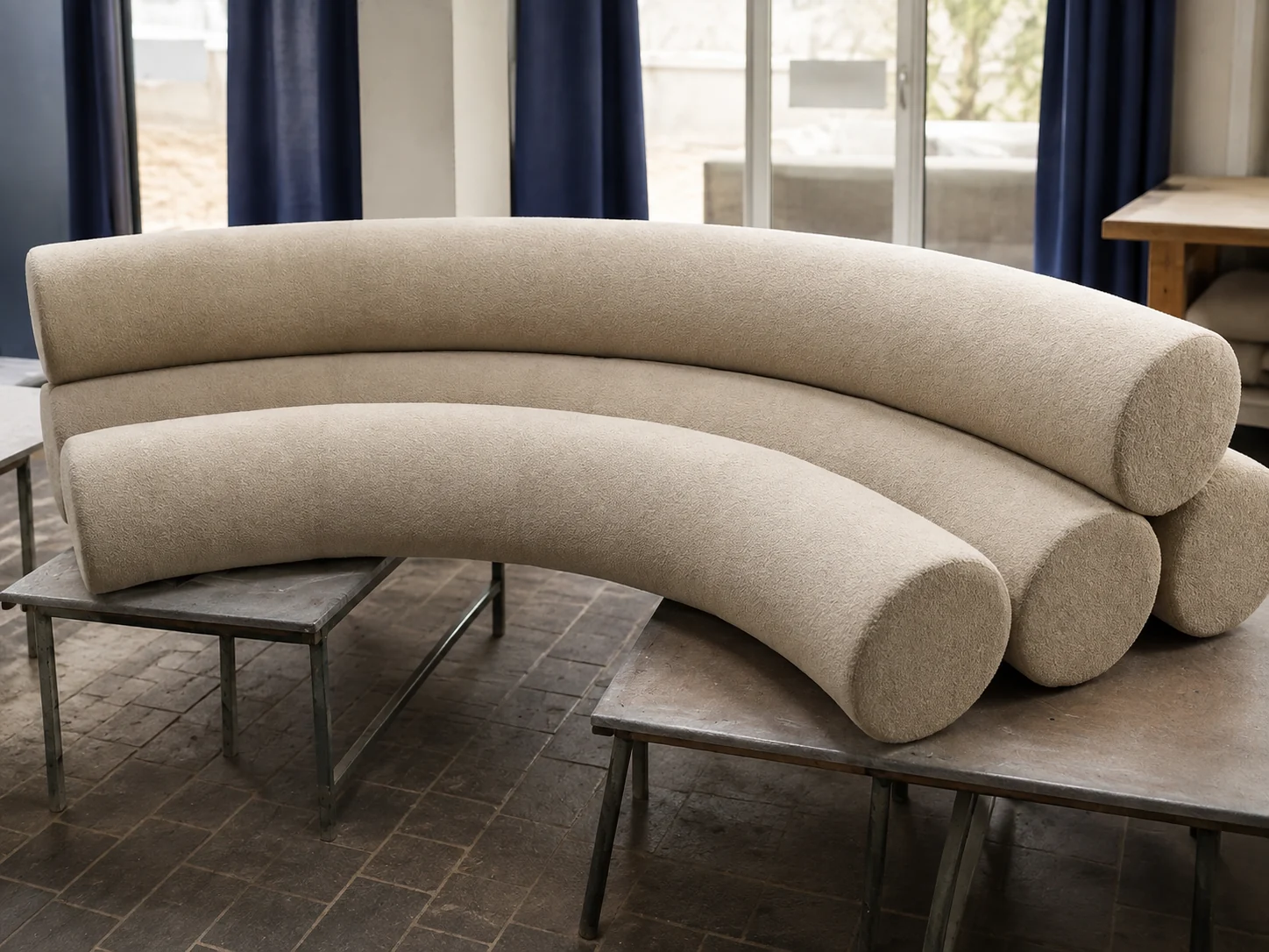 Completed light upholstered curved sofa after final finishing