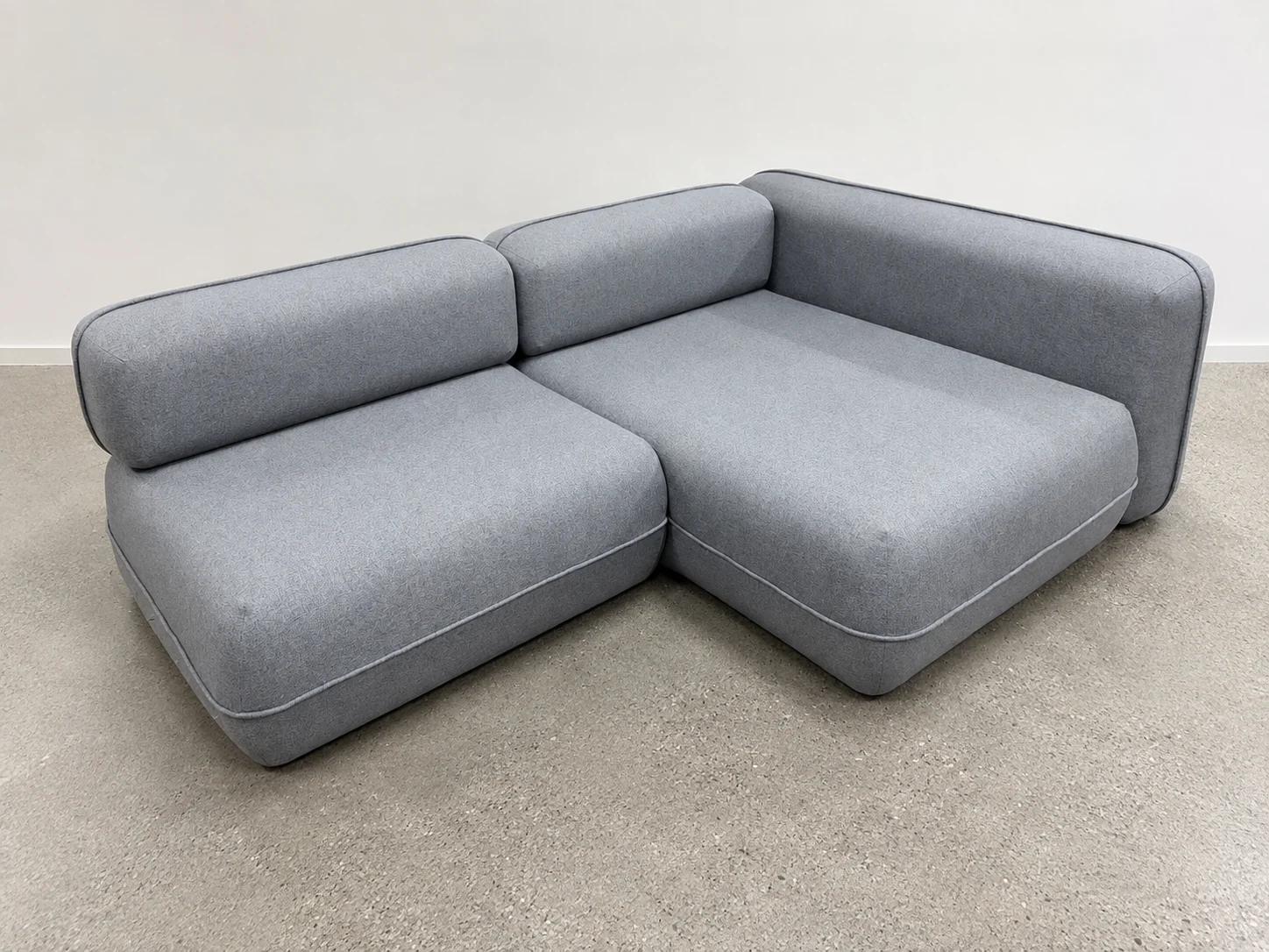 Completed gray upholstered modular sofa in the workshop