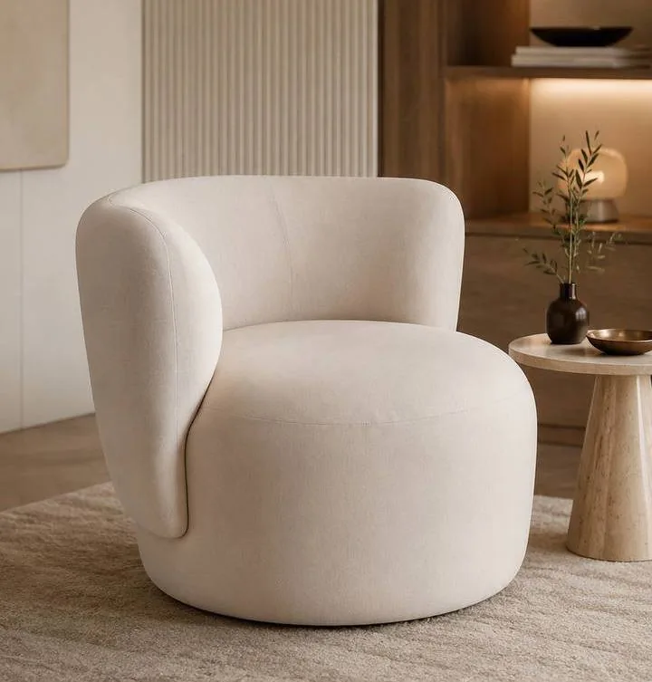 Sculptural cream boucle lounge chair with rounded arms and back.