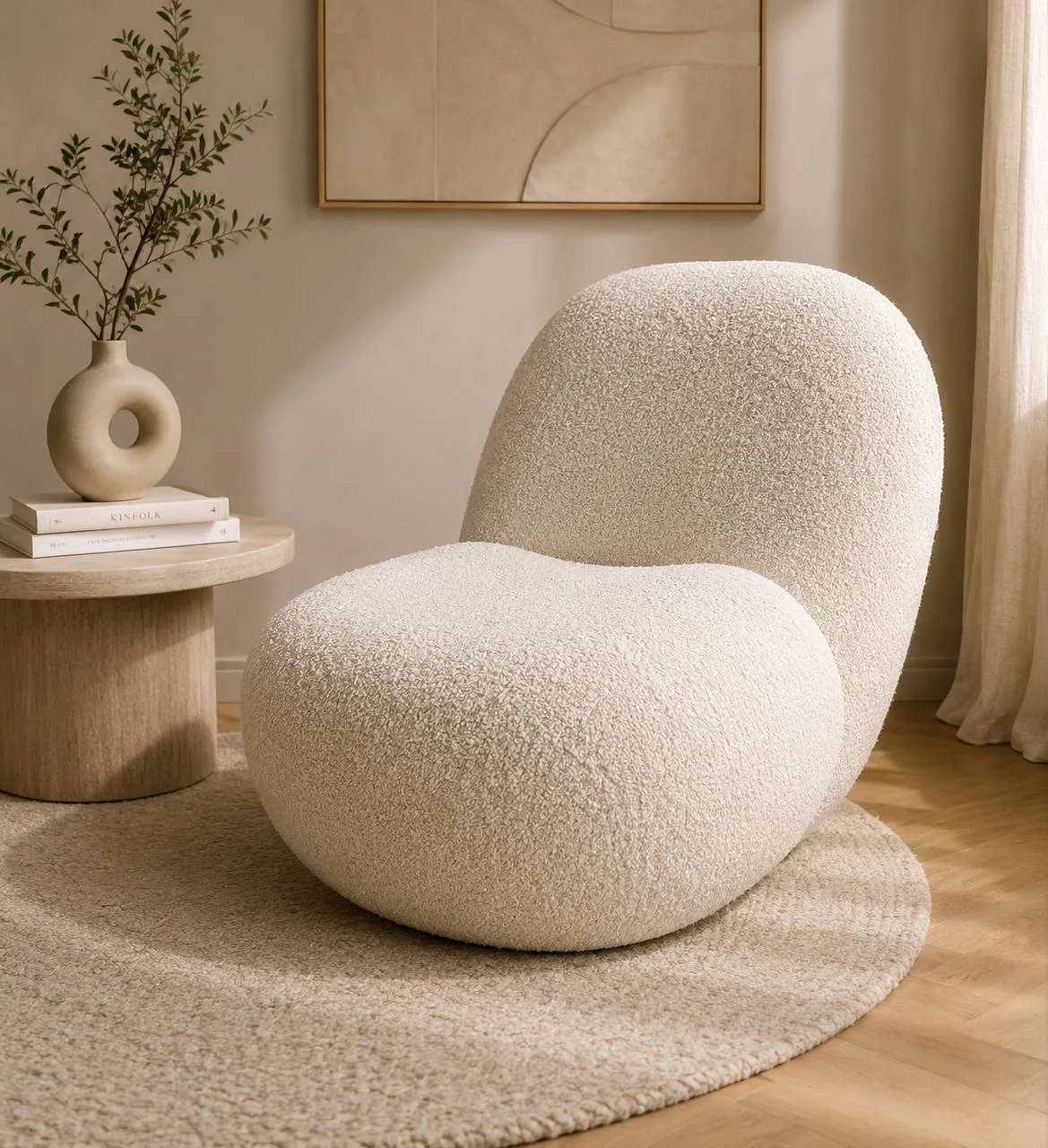 Soft cream upholstered lounge chair with a rounded back and seat.